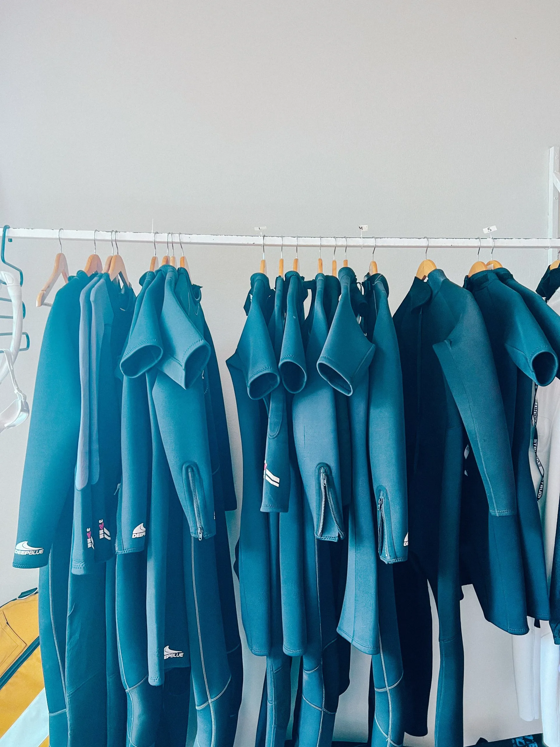 Wetsuits hanging